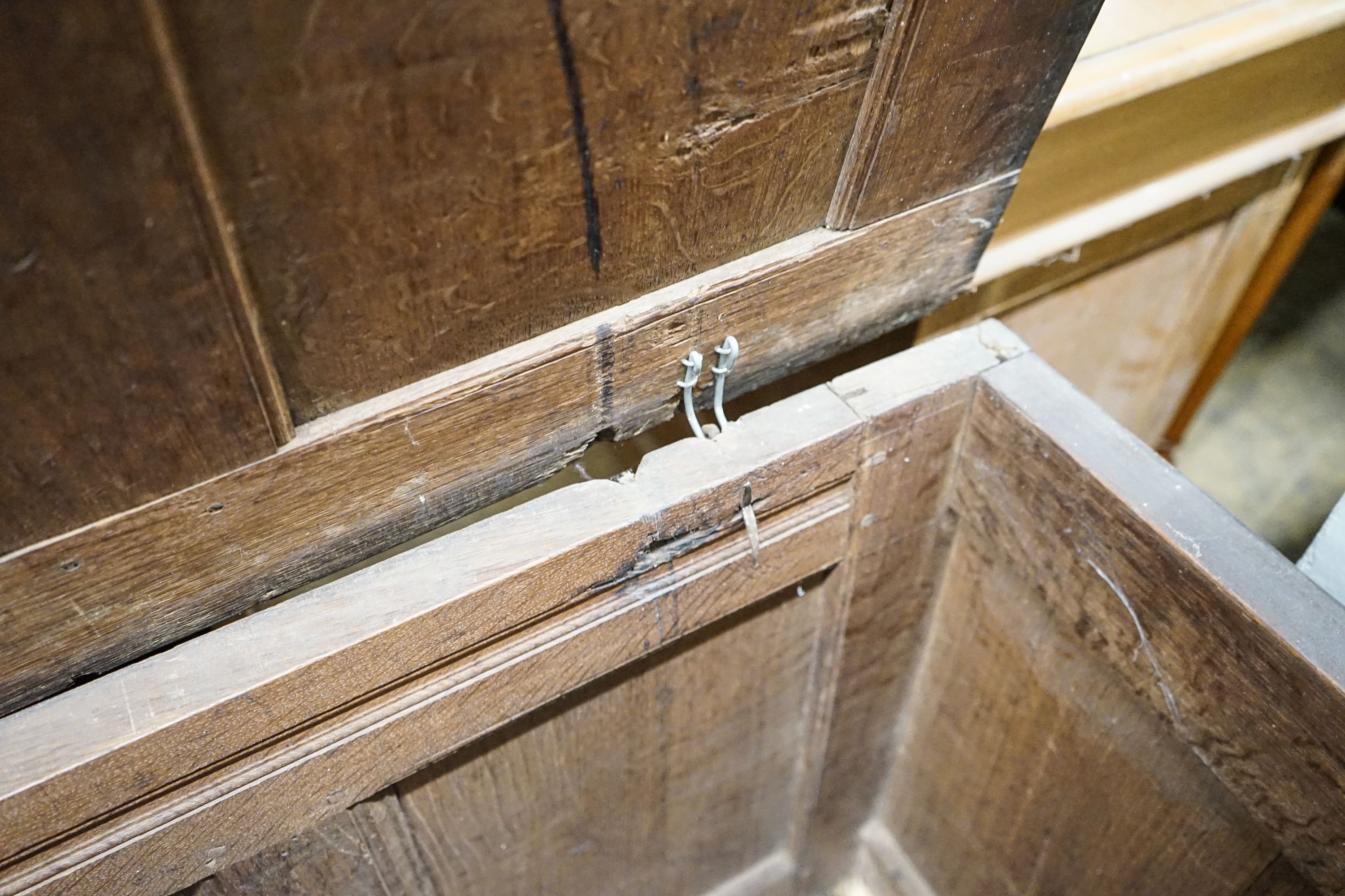 An early 18th century oak coffer, with four panel top and later carved and applied decoration, width 152cm, depth 63cm, height 74cm